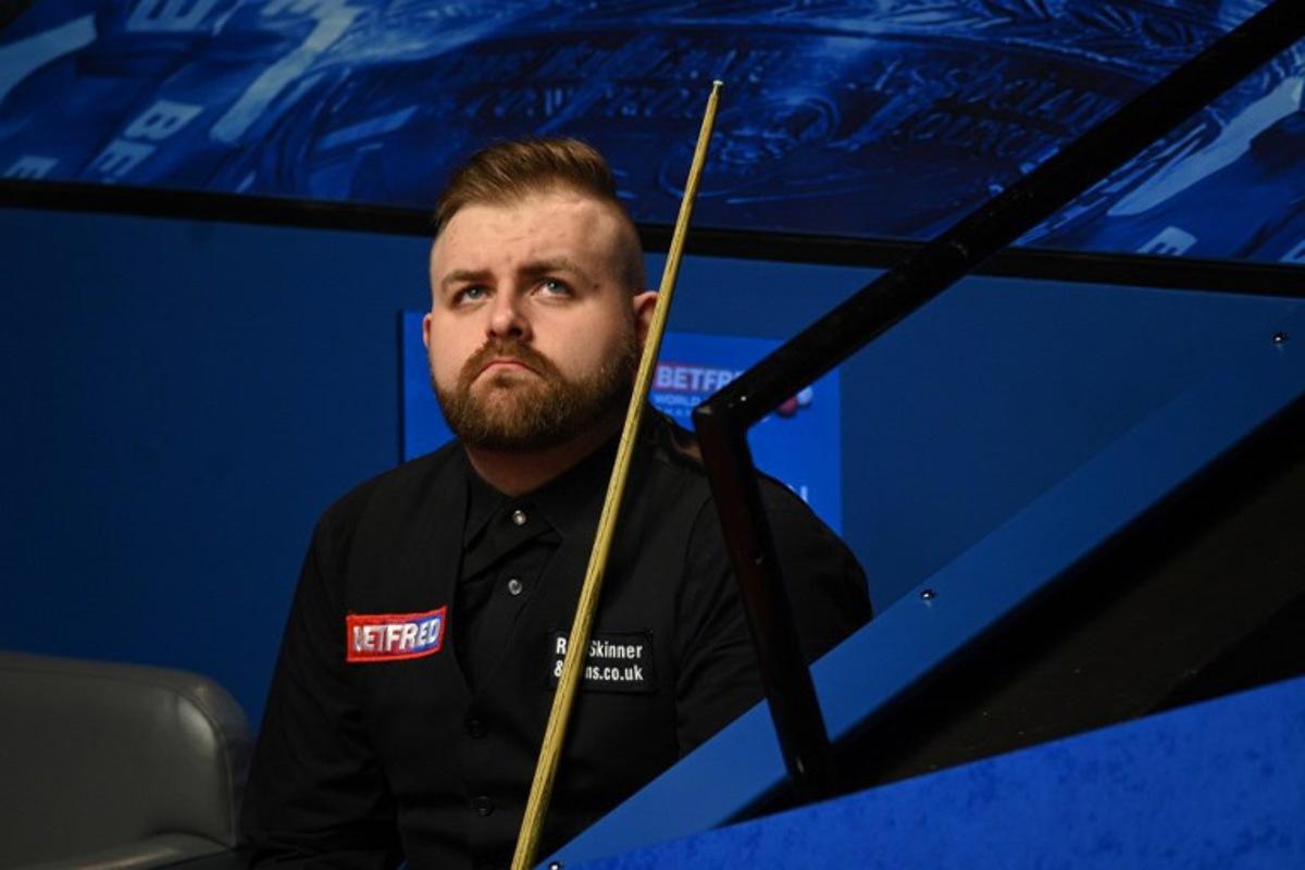 Jackson Page of Wales reacts during the World Snooker Championship Round Two match against Mark Williams of Wales at the Crucible Theatre, in Sheffield, northern England, on April 22, 2022. OLI SCARFF / AFP