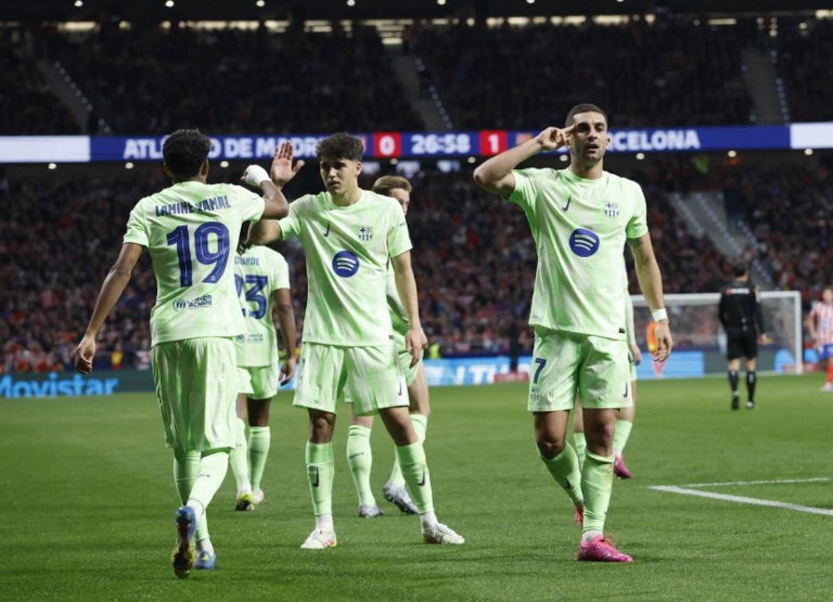 Barcelona's Spanish forward #07 Ferran Torres (R) celebrates scoring the opening goal during the Spanish Copa del Rey (King's Cup) semi-final second leg football match between Club Atletico de Madrid and FC Barcelona at Metropolitano Stadium in Madrid on April 2, 2025. Pierre-Philippe MARCOU / AFP