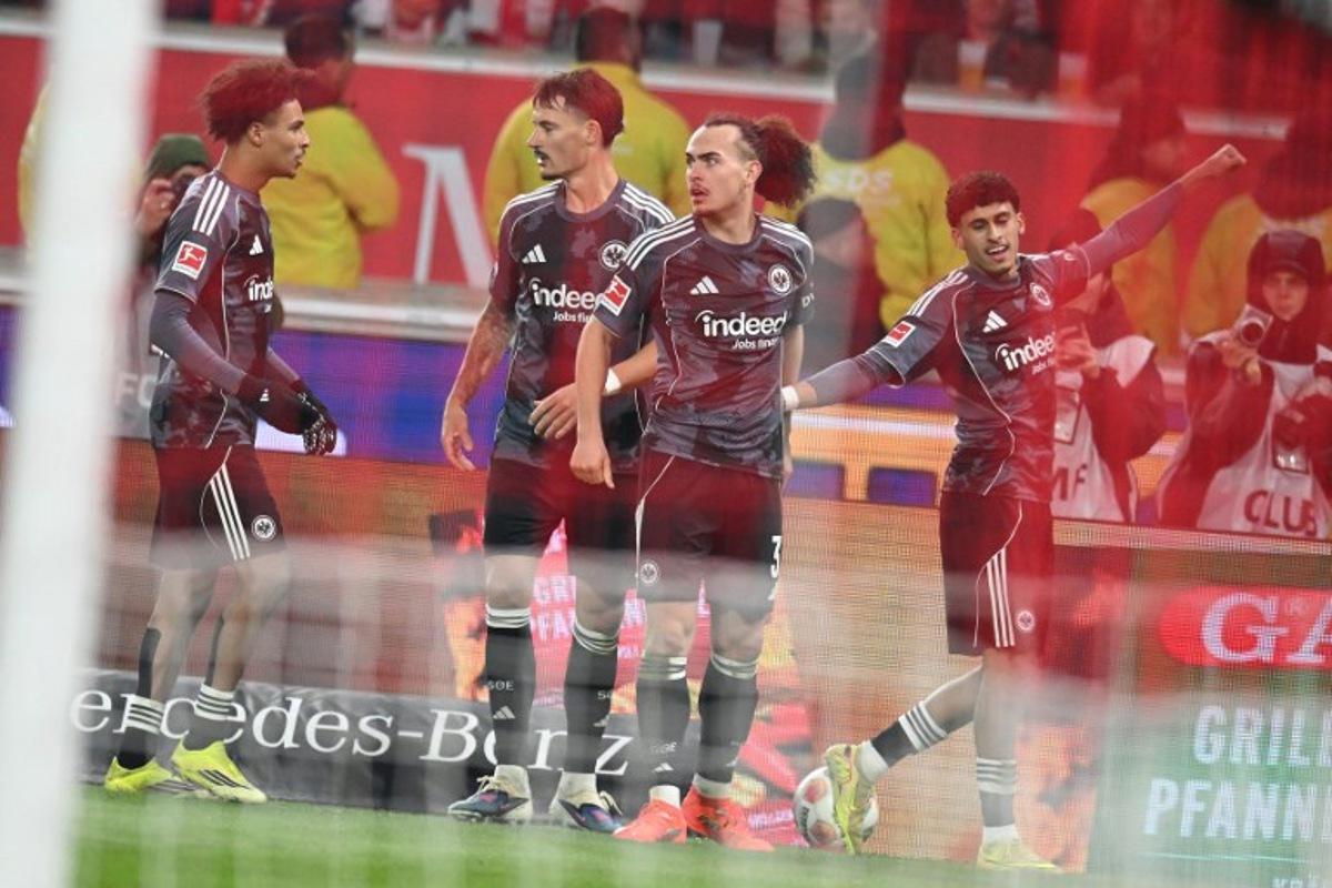Frankfurt's Moroccan forward #29 Ayoube Amaimouni-Echghouyab celebrates with his team mates after scoring the equalising goal during the German first division Bundesliga football match between VfB Stuttgart and Eintracht Frankfurt in Stuttgart, southern Germany, on January 13, 2026. THOMAS KIENZLE / AFP