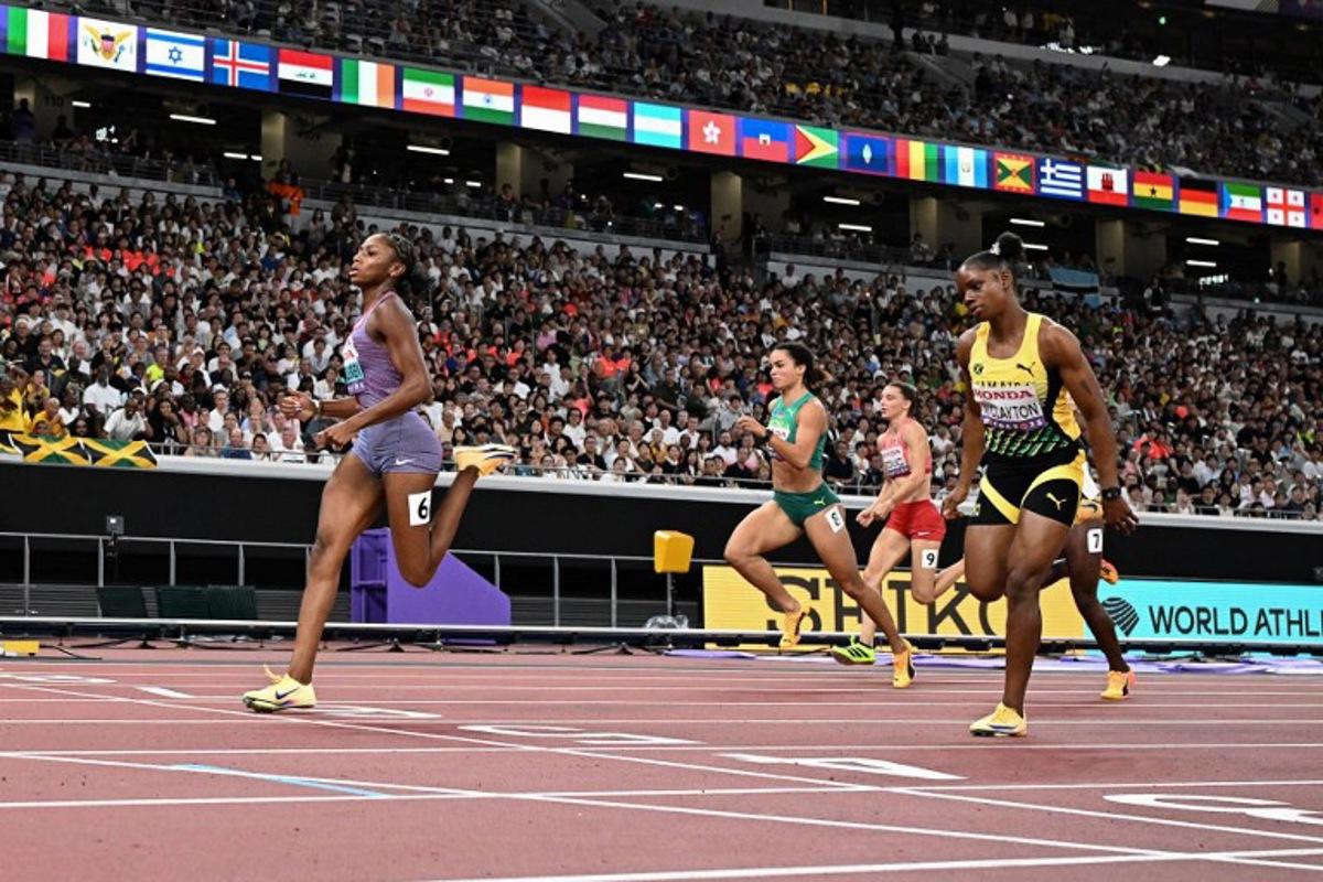 US' athlete Melissa Jefferson-Wooden (L) crosses the finish as she competes in the women's 100m semi-final during the World Athletics Championships in Tokyo on September 14, 2025. Jewel SAMAD / AFP