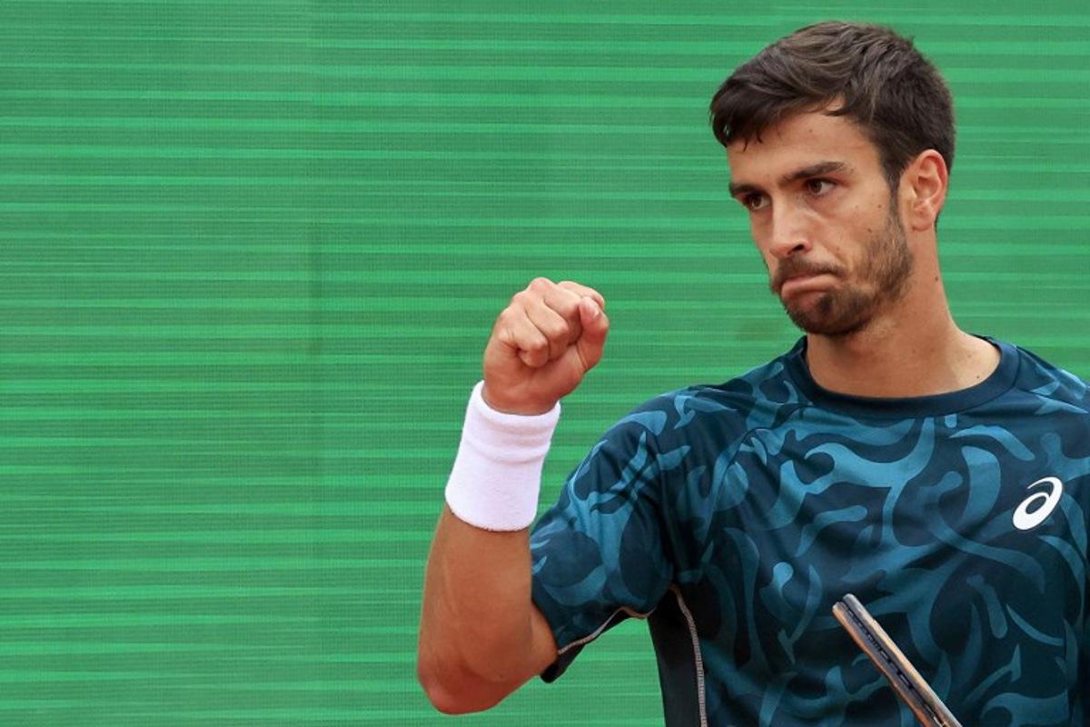 Italy's Lorenzo Musetti reacts after a point as he plays against Australia's Alex De Minaur during the Monte Carlo ATP Masters Series Tournament semi-final tennis match at the Monte Carlo Country Club in Roquebrune-Cap-Martin on April 12, 2025. Valery HACHE / AFP