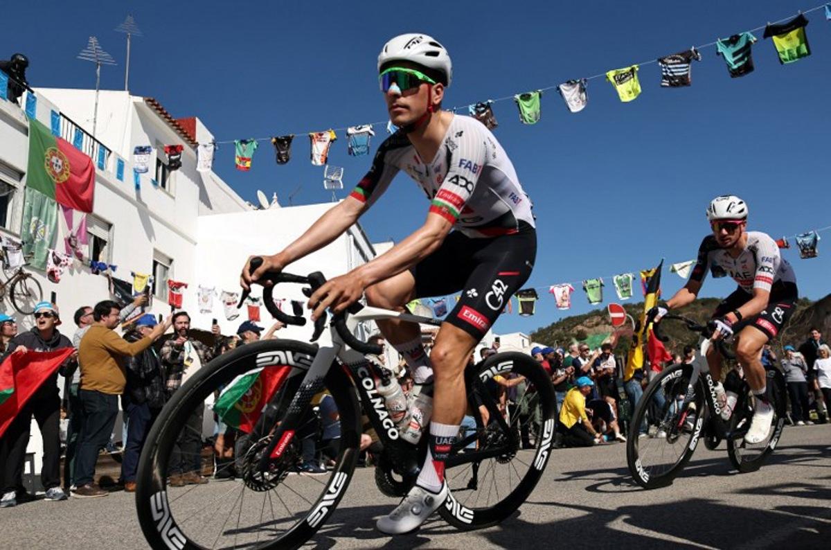 UAE Team Emirates XRG Portuguese cyclist Joao Almeida (L) rides in Alte during the second stage of the 52nd edition of the Volta ao Algarve, a 147.2 km race between Portimao and Foia, Monchique, on February 19, 2026. João Matos / AFP