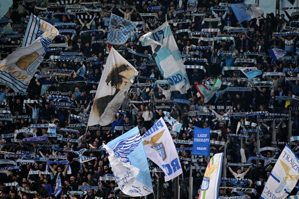 Lazio's supporters cheer their team before the Italian Serie A football match between Lazio and Roma at the Olympic Stadium in Rome on April 13, 2025. Tiziana FABI / AFP