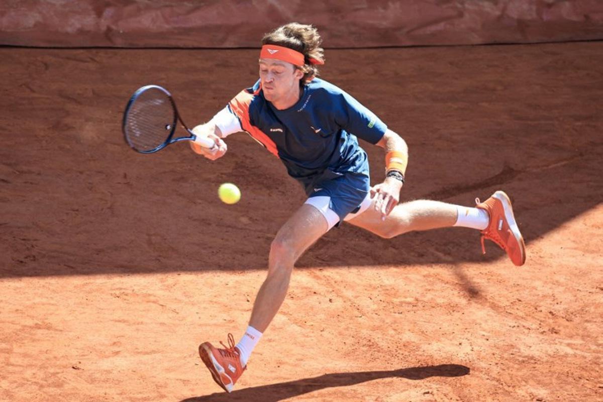 Russia's Andrey Rublev stretches to play a forehand return to France's Arthur Fils during the Monte Carlo ATP Masters Series Tournament round of 16 tennis match on the Court des Princes at the Monte Carlo Country Club in Roquebrune-Cap-Martin on April 10, 2025. Valery HACHE / AFP
