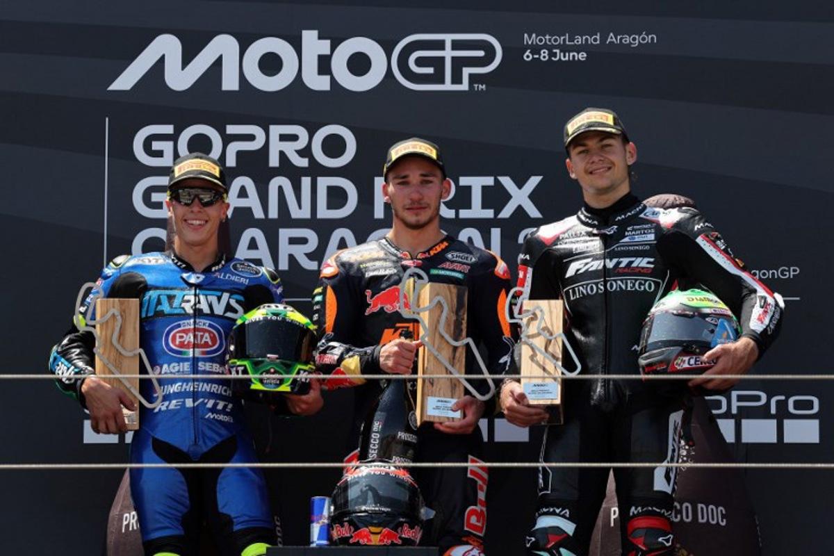 Winner Red Bull KTM Ajo's Deniz Oncu (C), second placed Italtrans Racing Team's Brazilian rider Diogo Moreira (L) and third placed Fantic Racing's Belgian rider Barry Baltus celebrate on the podium after the Moto2 race of the MotoGP Aragon Grand Prix at the Motorland circuit in Alcaniz, northeastern Spain, on June 8, 2025. LLUIS GENE / AFP
