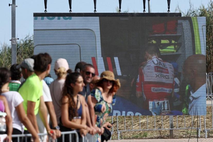 Team UAE's Slovenian rider Tadej Pogacar is seen entering an ambulance after crashing on a giant screen in the finish area of the Vuelta a Espana 2026, a 171 km race between Pucol and Xeraco on August 29, 2026. Race leader Tadej Pogacar pulled out of the Vuelta a Espana on Saturday after a heavy fall 31km from the finish of a flat stage eight left him with shoulder and face injuries. Pogacar of Team UAE has won five Tour de France titles and a Giro d'Italia and was targeting his first overall victory on the Spanish 21-day race. Josep LAGO / AFP