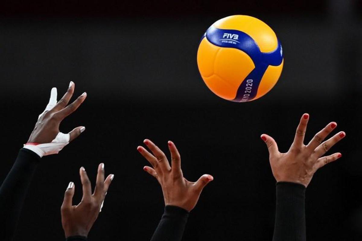 This picture shows the hands of Dominican Republic's Brayelin Martinez (L) and Prisilla Rivera Brens as they try to block a shot in the women's quarter-final volleyball match between USA and Dominican Republic during the Tokyo 2020 Olympic Games at Ariake Arena in Tokyo on August 4, 2021. YURI CORTEZ / AFP
