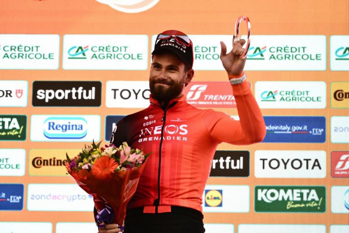 Ineos' Italian rider Filippo Ganna, second, celebrates during the podium ceremony of the Milan - Sanremo one-day classic cycling race, on March 22, 2025. Dutch Mathieu Van Der Poel of team Alpecin-Deceuninck won the race ahead of Team Ineos' Italian rider Filippo Ganna and Team UAE's Slovenian rider Tadej Pogacar, third. Marco BERTORELLO / AFP