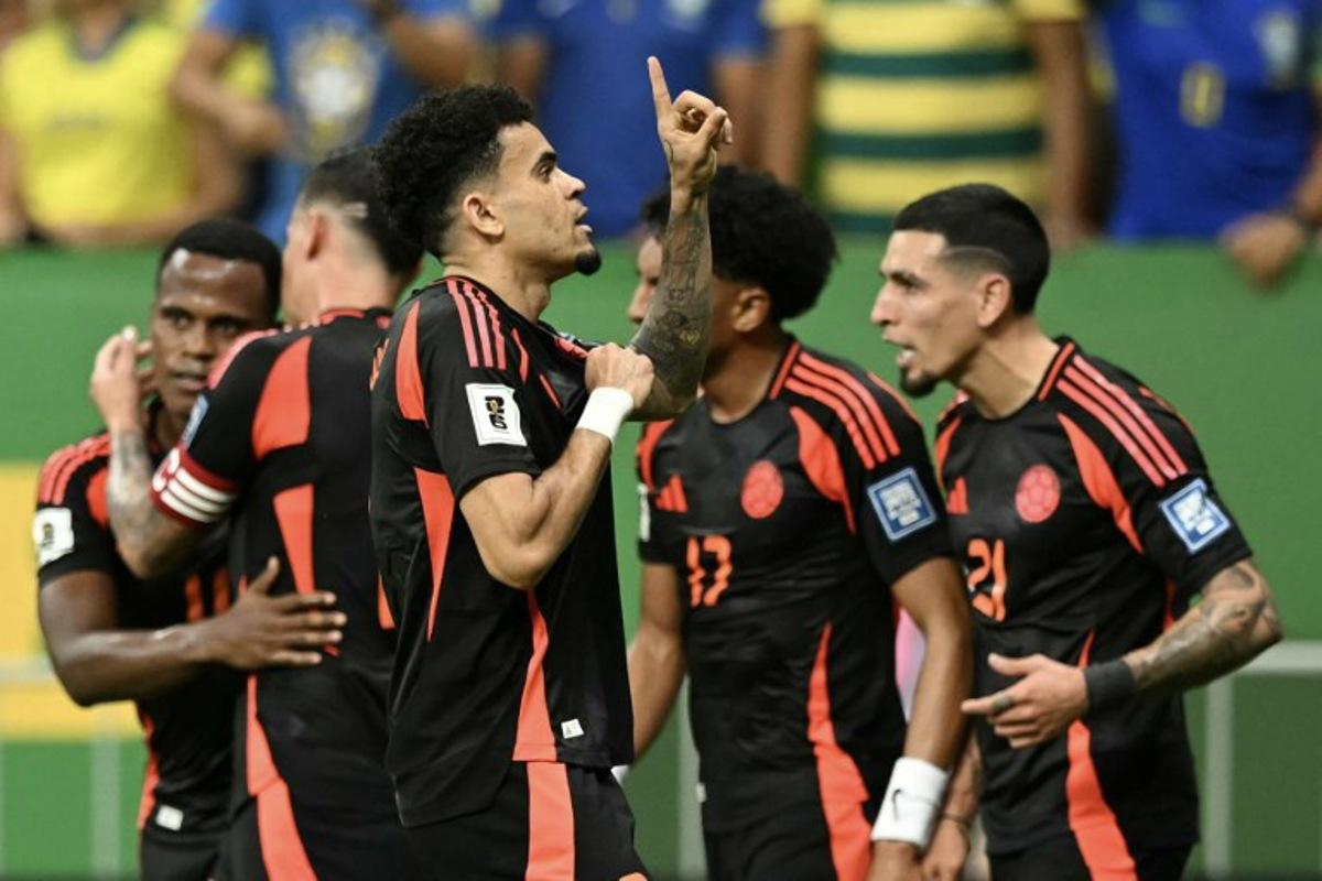 Colombia's forward #07 Luis Diaz (C) celebrates with teammates after scoring during the 2026 FIFA World Cup South American qualifiers football match between Brazil and Colombia, at the Mane Garrincha stadium in Brasilia, on March 20, 2025. EVARISTO SA / AFP