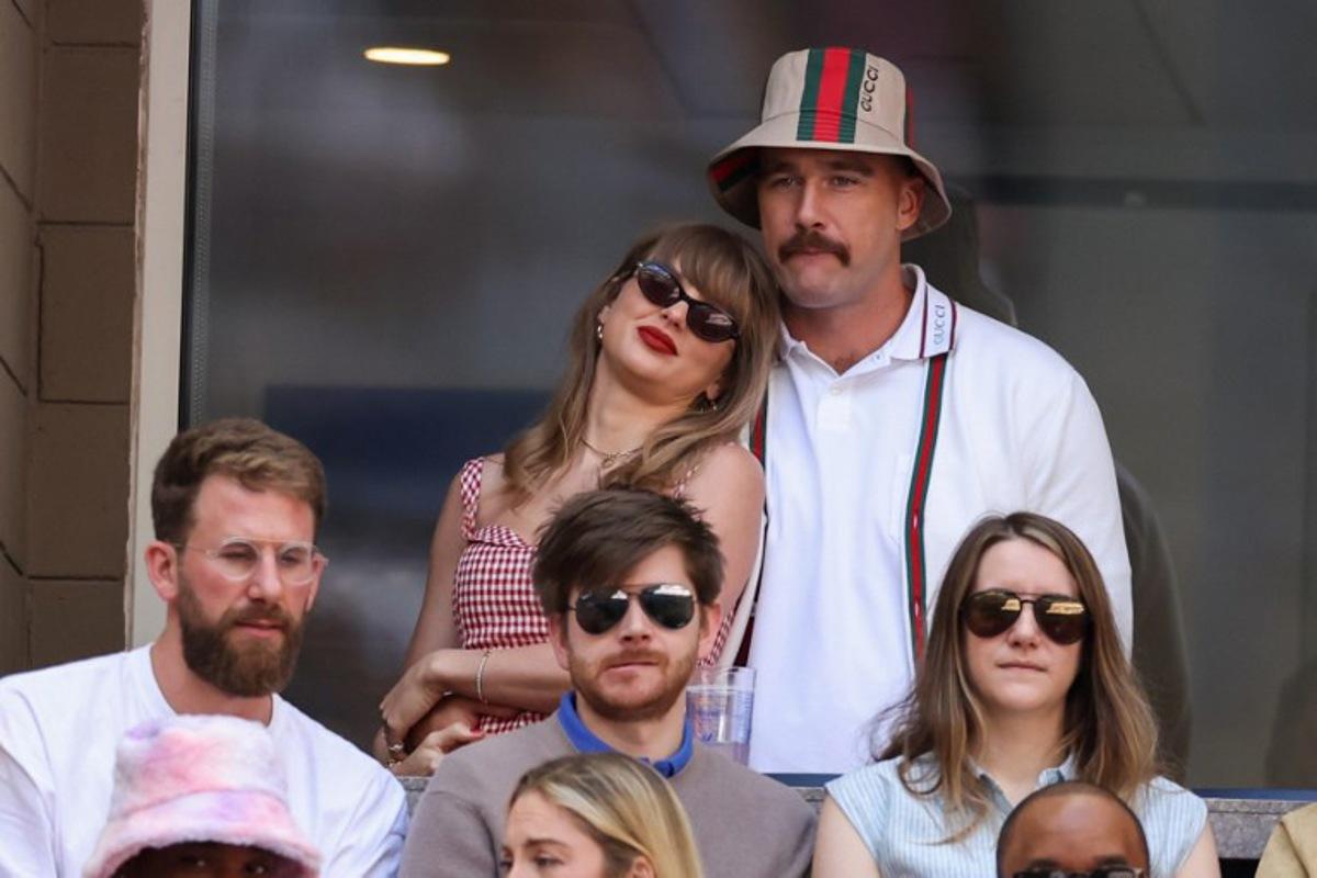 US musician Taylor Swift (L) and US NFL football player Travis Kelce (R) attend the men's final match between Italy's Jannik Sinner and USA's Taylor Fritz on day fourteen of the US Open tennis tournament at the USTA Billie Jean King National Tennis Center in New York City, on September 8, 2024. CHARLY TRIBALLEAU / AFP