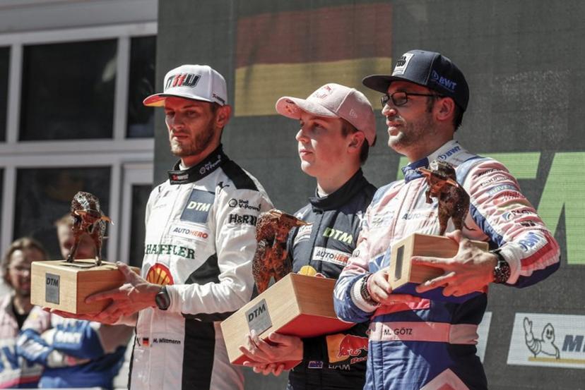 Second placed Germany's Marco Wittmann of the Walkenhors Motorsport Team (L), first placed New Zealand's Liam Lawson of the Red Bull Alphatauri AF Corse Team and third placed Germany's Maximilian Goetz of the Haupt Racing Team Team stand on the podium during the winners' ceremony after the end of the second race of the DTM of Austria, on September 5, 2021 at the Red Bull Ring in Spielberg, Austria. ERWIN SCHERIAU / APA / AFP