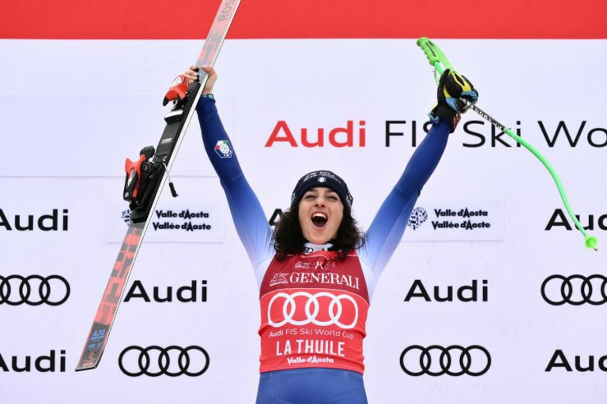 Italy's Federica Brignone celebrates on the podium of the Women's Super G replacing St Moritz event of FIS Alpine Skiing World Cup in La Thuile, Italy on March 14, 2025. Italy's Federica Brignone won the race ahead of Italy's Sofia Goggia and France's Romane Miradoli, third. A sensational run from Brignone gave her victory in the Italian alps by just 0.01sec over her compatriot Sofia Goggia. It extended her lead in the overall standings on Lara Gut-Behrami to 382 points. Marco BERTORELLO / AFP