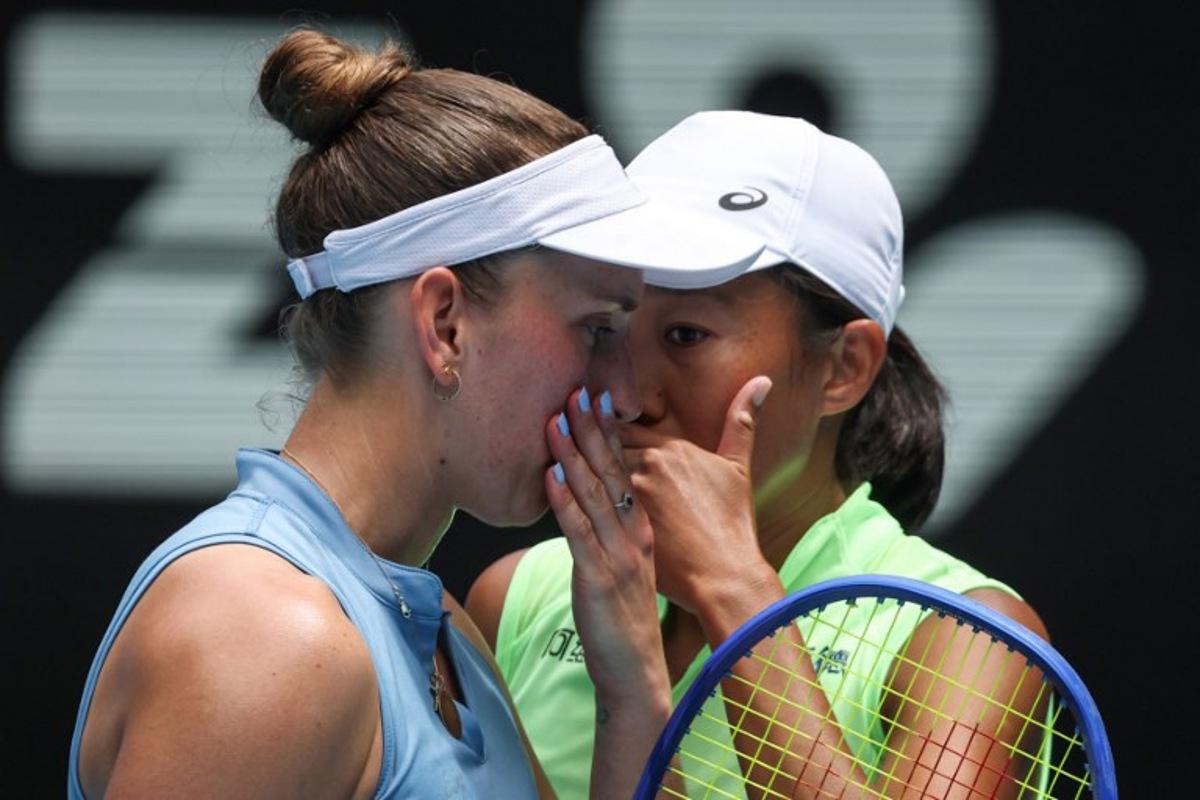Belgium's Elise Mertens talks to partner China's Zhang Shuai (R) during their women's doubles final match against Kazakhstan's Anna Danilina and Serbia's Aleksandra Krunic on day fourteen of the Australian Open tennis tournament in Melbourne on January 31, 2026. DAVID GRAY / AFP