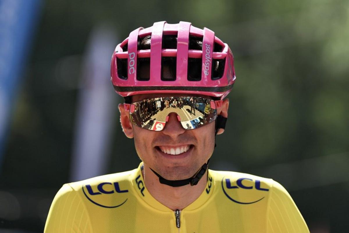 EF Education - EasyPost's French rider Alex Baudin wearing the overall leader's yellow jersey awaits the start of the 2nd stage of the Tour Auvergne-Rhone-Alpes cycling race (formerly known as the Criterium du Dauphine), 234,3km between Saint-Martin-Le-Vinoux and Le Puy-en-Velay, in the French Alps, on June 8, 2026. Anne-Christine POUJOULAT / AFP