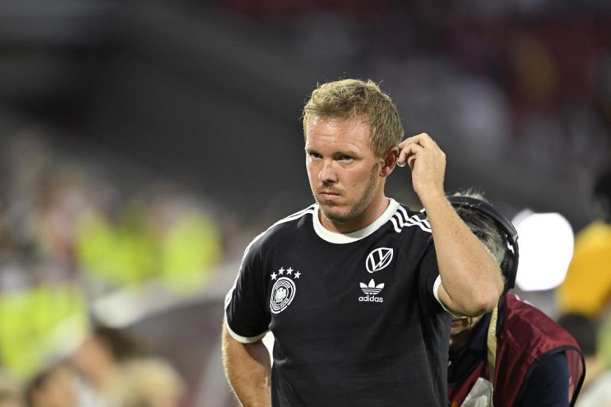 Germany's headcoach Julian Nagelsmann adjusts the earpiece as he wears the national team jersey prior to the start of the 2026 World Cup qualifiers Europe zone group A football match between Germany and Northern Ireland on September 7, 2025 in Cologne, western Germany. INA FASSBENDER / AFP
