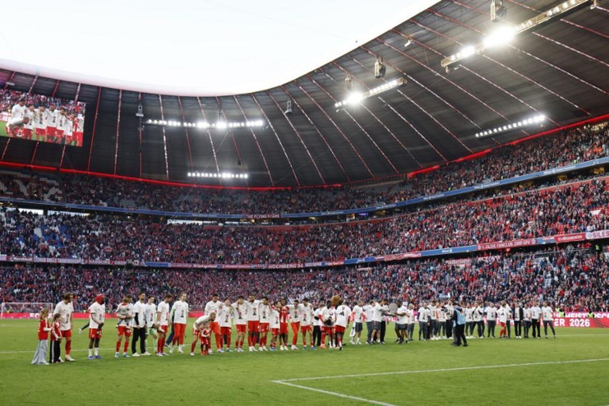 FC Bayern Munich's team celebrates with fans after winning the German first division Bundesliga football match between FC Bayern Munich and VfB Stuttgart in Munich, southern Germany, on April 19, 2026. Harry Kane scored his 32nd goal of the campaign as Bayern Munich cruised to a 4-2 home win over Stuttgart and claim a record-extending 35th Bundesliga title. Alexandra BEIER / AFP