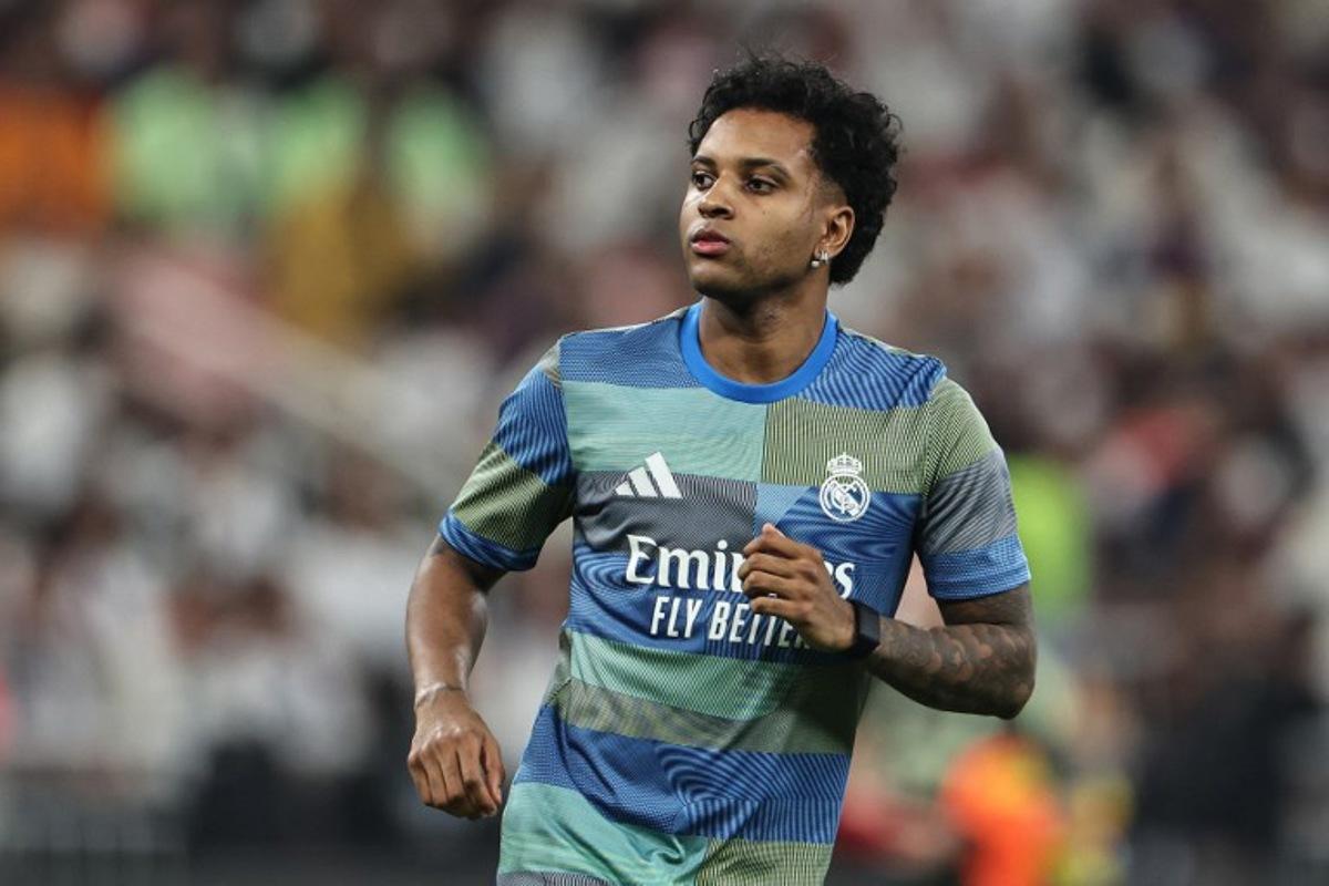 Real Madrid's Brazilian forward #11 Rodrygo warms up prior to the start of the Spanish Super Cup final football match between FC Barcelona and Real Madrid at the King Abdullah Stadium in Jeddah on January 11, 2026. Fadel SENNA / AFP
