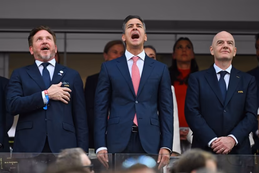 (L-R) CONMEBOL President Alejandro Dominguez and Paraguayan President Santiago Pena sing the Paraguayan national anthem next to FIFA president Gianni Infantino ahead of the 2026 World Cup Group D football match between USA and Paraguay at the Los Angeles Stadium in Inglewood on June 12, 2026. Patrick T. Fallon / AFP