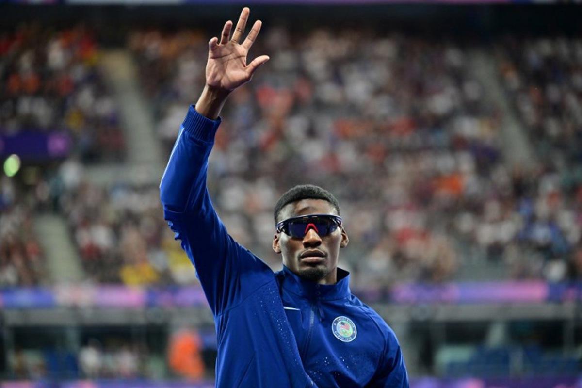 Bronze medallist US' Fred Kerley celebrates on the podium during the victory ceremony for the men's 100m athletics event during the Paris 2024 Olympic Games at Stade de France in Saint-Denis, north of Paris, on August 5, 2024. Martin BERNETTI / AFP