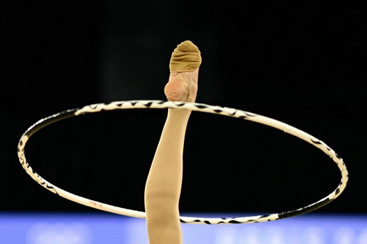 Romania's Annaliese Dragan performs with the hoop as she competes in the rhytmic gymnastics' individual all-around qualification during the Paris 2024 Olympic Games at the Porte de la Chapelle Arena in Paris, on August 8, 2024. Loic VENANCE / AFP