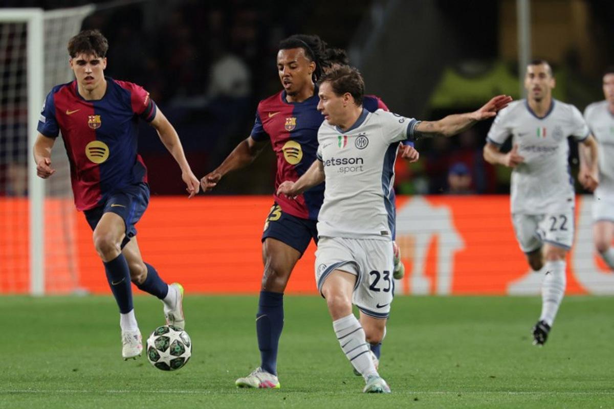 Barcelona's French defender #23 Jules Kounde (2L) and Inter Milan's Italian midfielder #23 Nicolo Barella vie for the ball during the UEFA Champions League semi final first leg football match between FC Barcelona and Inter Milan at the Estadi Olimpic Lluis Companys in Barcelona on April 30, 2025. LLUIS GENE / AFP