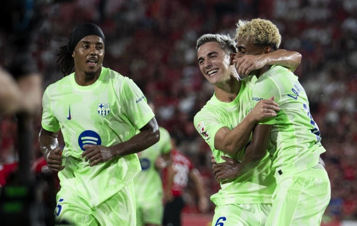 Barcelona's Spanish forward #10 Lamine Yamal (R) celebrates scoring his team's third goal with Barcelona's Spanish midfielder #06 Pablo Gavi during the Spanish league football match between RCD Mallorca and FC Barcelona at Mallorca Son Moix Stadium in Palma de Mallorca on August 16, 2025. JAIME REINA / AFP