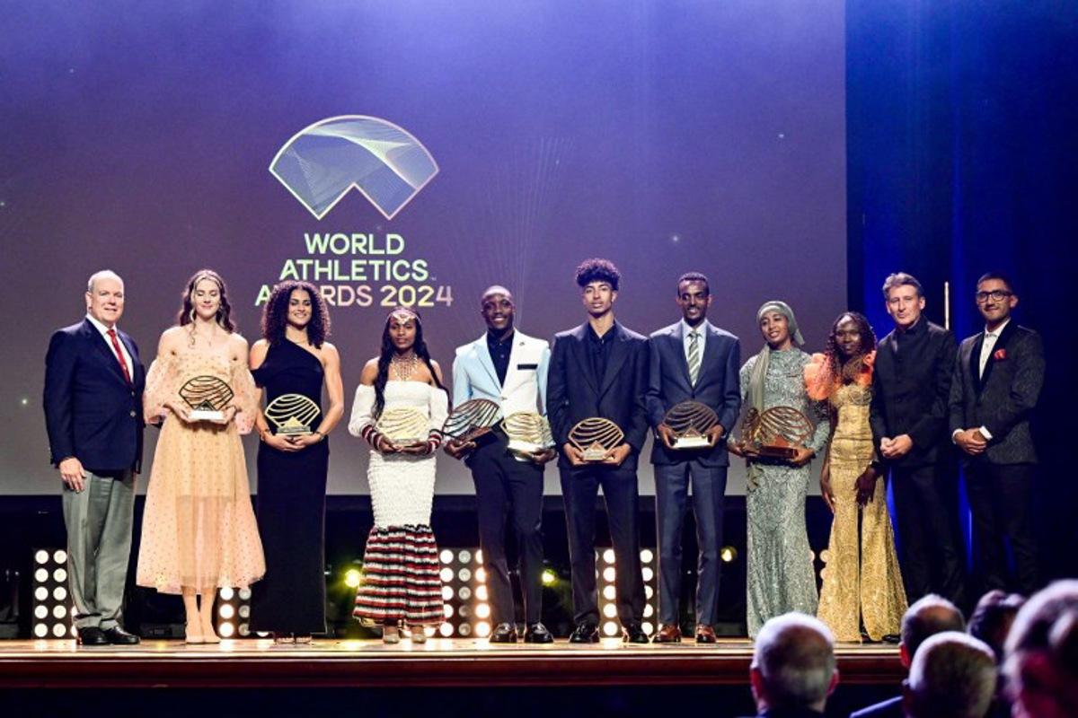 (From L) Prince Albert II of Monaco, the laureates holding their awards, Ukrainian high jumper Yaroslava Mahuchikh (Women's field athlete of the year), US hurdler Sydney McLaughlin-Levrone (Women's track athlete of the year), Ethiopian athlete Sembo Almayew (Women's rising star), Botswanan sprinter Letsile Tebogo (Men's track athlete of the year), Italian high jumper Mattia Furlani (Men's rising star), Ethiopian long-distance runner Tamirat Tola (Men's out of stadium athlete of the year) and Dutch middle and long-distance runner Sifan Hassan (Women's out of stadium athlete of the year) and World Atheltics President Sebastian Coe and Ecuadorian racewalker Brian Pintado pose on stage during the World Athletics Awards 2024 in Monaco on December 1, 2024. FREDERIC DIDES / AFP