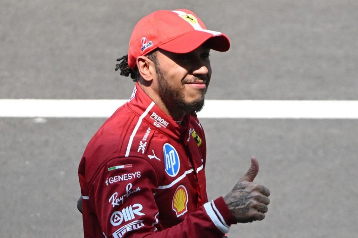 Ferrari's British driver Lewis Hamilton celebrates after winning the sprint race of the Formula One Chinese Grand Prix at the Shanghai International Circuit in Shanghai on March 22, 2025. JADE GAO / AFP