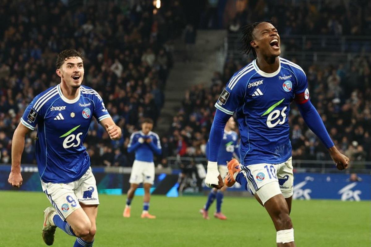 Strasbourg's Dutch forward #10 Emanuel Emegha (R) celebrates with Strasbourg's Argentine forward #09 Joaquin Panichelli after scoring his team's second goal during the French L1 football match between RC Strasbourg Alsace and Lille LOSC at the Stade de la Meinau in Strasbourg, eastern France, on November 9, 2025. Frederick FLORIN / AFP