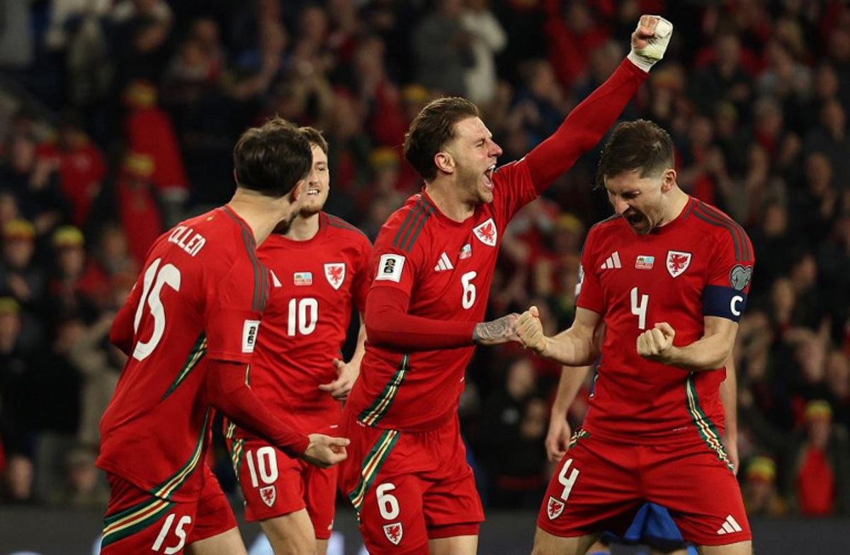 Wales' defender #04 Ben Davies (R) celebrates scoring the team's second goal during the 2026 World Cup Group J qualifier football match between Wales and Kazakhstan, at Cardiff City Stadium, in Cardiff, on March 22, 2025. Adrian Dennis / AFP