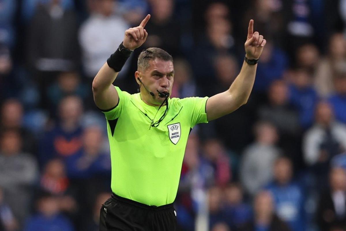 Romanian referee Istvan Kovacs gestures during the UEFA Europa League quarter final football match between Rangers and Athletic Club Bilbao at the Ibrox Stadium in Glasgow on April 10, 2025. Ewan Bootman / AFP
