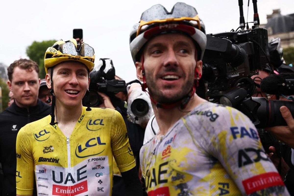 UAE Team Emirates - XRG team's Slovenian rider Tadej Pogacar celebrates his overall victory with UAE Team Emirates - XRG team's British rider Adam Yates after the 21st and final stage of the 112th edition of the Tour de France cycling race, 132.3 km between Mantes-la-Ville and Paris Champs-Élysees, on July 27, 2025. Anne-Christine POUJOULAT / AFP