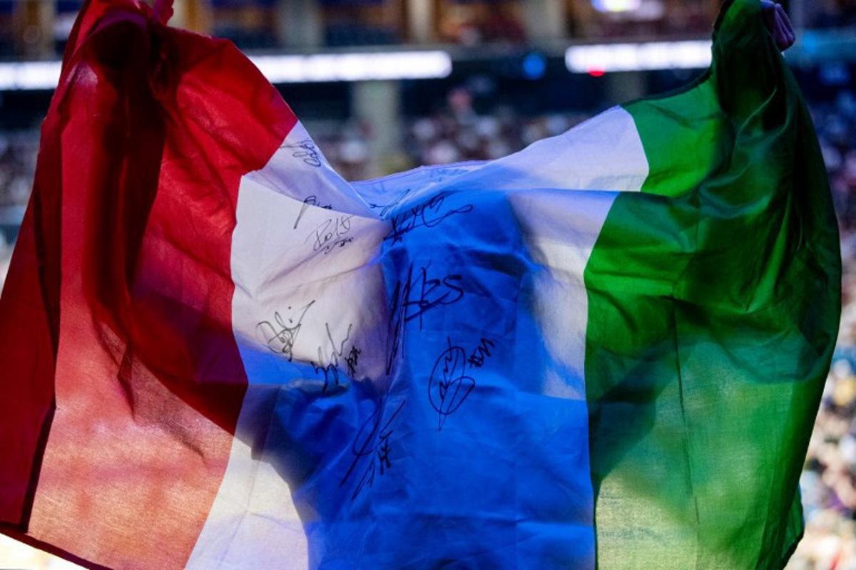 An Italian fan displays a national flag during the 2025 Men's Volleyball World Championship semi-final match between Italy and Poland at the Mall of Asia Arena in Pasay City, Metro Manila on September 27, 2025. Ted ALJIBE / AFP