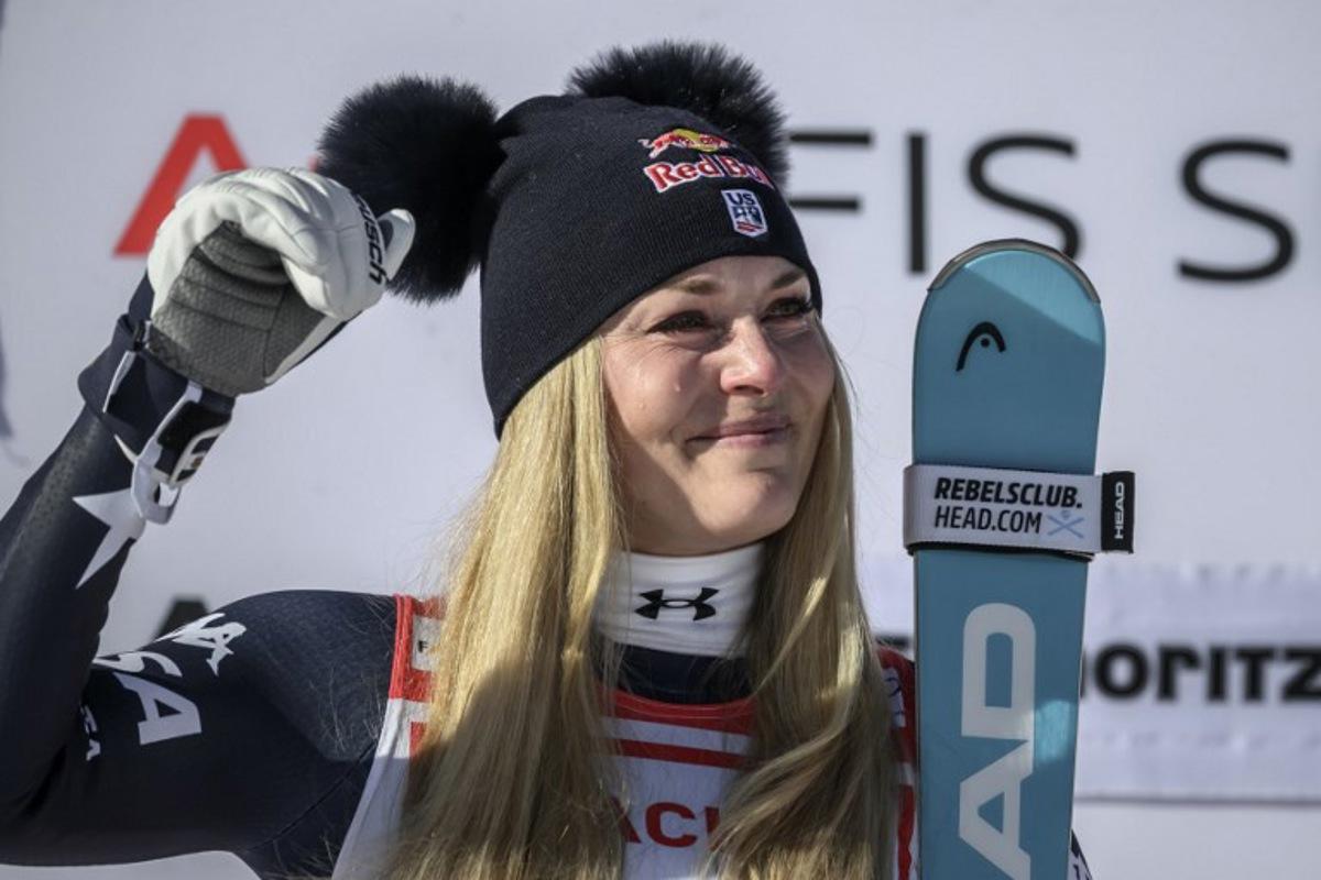 First-placed US Lindsey Vonn cries on the podium as she celebrates after competing in the women's downhill race during the FIS Alpine Ski World Cup 2025-2026, in St Moritz, south-eastern Switzerland on December 12, 2025. Fabrice COFFRINI / AFP