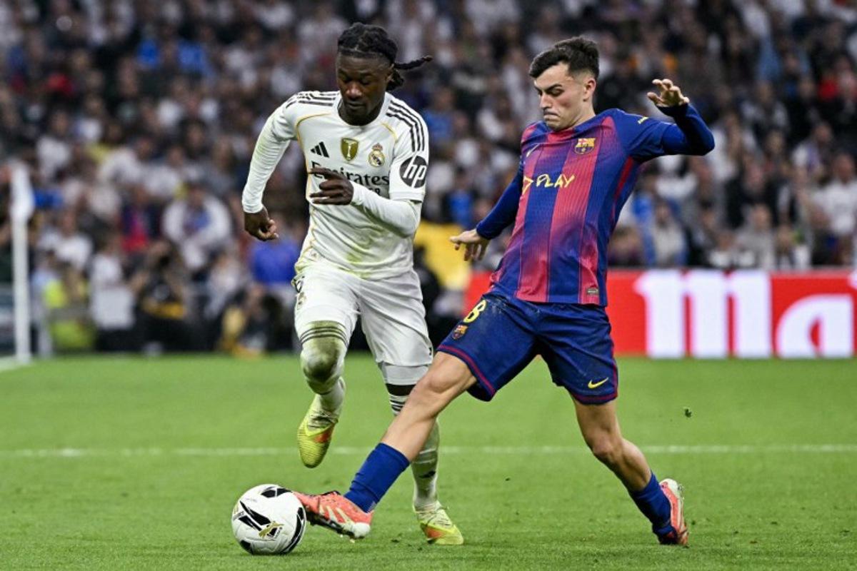 Real Madrid's French midfielder #06 Eduardo Camavinga (L) vies for the ball with Barcelona's Spanish midfielder #08 Pedri during the Spanish league football match between Real Madrid CF and FC Barcelona at the Santiago Bernabeu stadium in Madrid on October 26 , 2025. JAVIER SORIANO / AFP