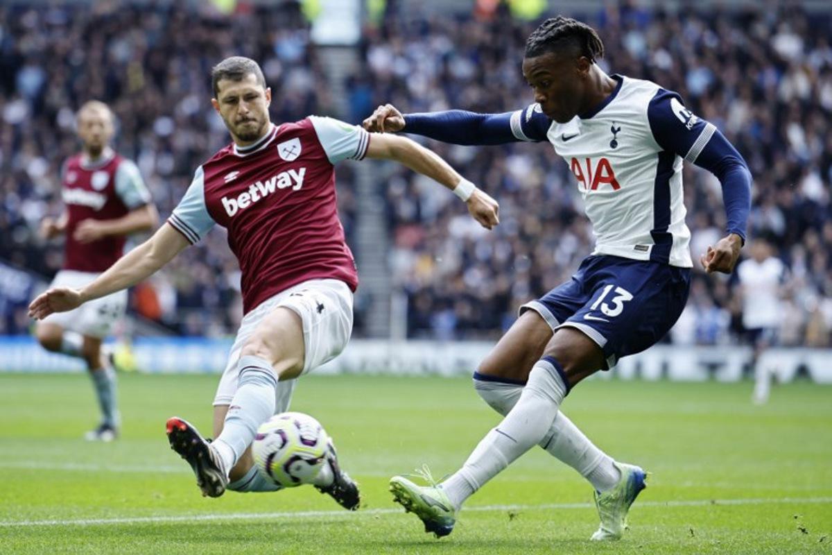 Tottenham Hotspur's Italian defender #13 Destiny Udogie (R) crosses the ball past West Ham's Argentinian midfielder #24 Guido Rodriguez (L) during the English Premier League football match between Tottenham Hotspur and West Ham United at the Tottenham Hotspur Stadium in London, on October 19, 2024. BENJAMIN CREMEL / AFP