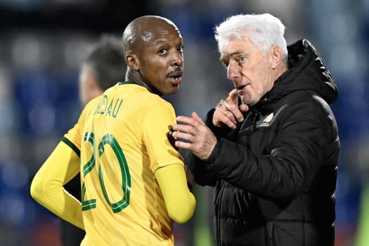 South Africa's head coach Hugo Broos (R) gives instructions to South Africa's defender #20 Khuliso Mudau (L) during the Africa Cup of Nations (CAN) Group B football match between South Africa and Angola at Marrakesh Stadium in Marrakesh, Morocco on December 22, 2025. Khaled DESOUKI / AFP