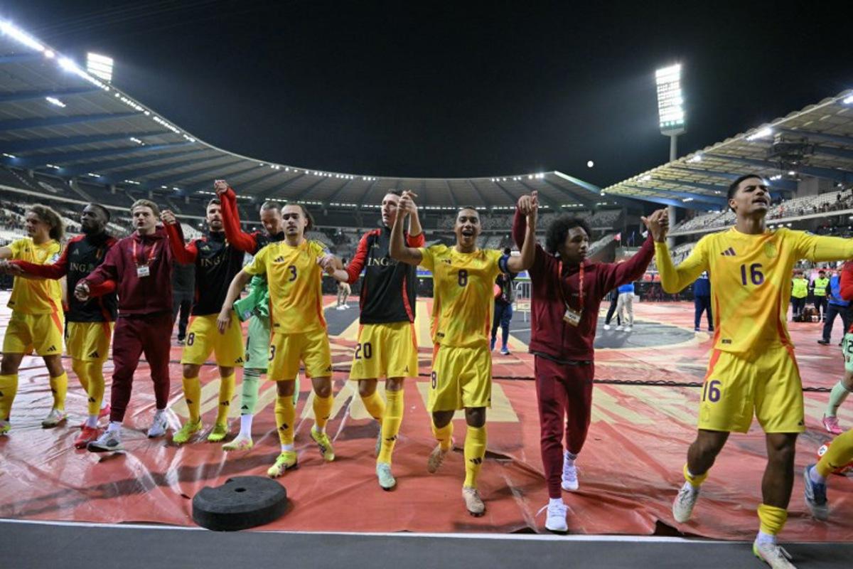 Belgium's players celebrate their victory at the end of the FIFA World Cup 2026 Group J European qualification football match between Belgium and Wales at the King Baudouin Stadium in Brussels, on June 9, 2025. NICOLAS TUCAT / AFP