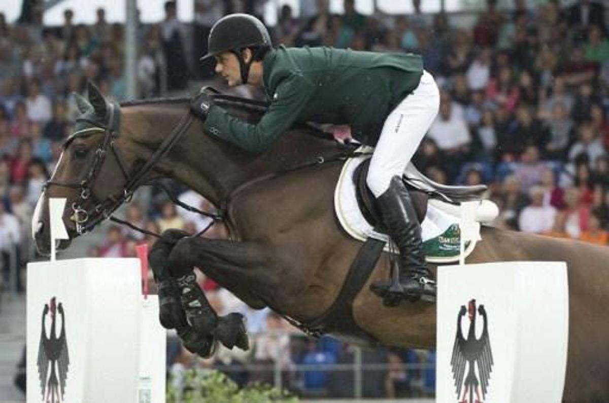 Ireland's Billy Twomey on Je t'Aime Flamenco clears an obstacle during the first round of the Jumping Nation's Cup at the World Equestrian Festival CHIO, in Aachen, on July 5, 2012. Ireland took third place. The CHIO, the last major equestrian event before the London Olympics, takes place from July 3 to 8. AFP PHOTO / JOHN MACDOUGALL