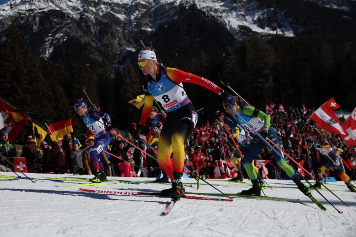 France's Oceane Michelon (L), Belgium's Maya Cloetens (C) and Slovenia's Anamarija Lampic (R) compete during the Women 10 km Pursuit event of the IBU Biathlon World Championship of Lenzerheide, eastern Switzerland, on February 16, 2025. FRANCK FIFE / AFP