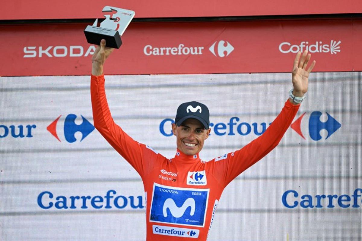 Overall race leader Team Movistar's Spanish rider Enric Mas celebrates retaining the race lead on the podium after the 14th stage of the Vuelta a Espana 2026 cycling tour, a 154,5 km race between Jaen and Sierra de la Pandera, on September 5, 2026. JORGE GUERRERO / AFP