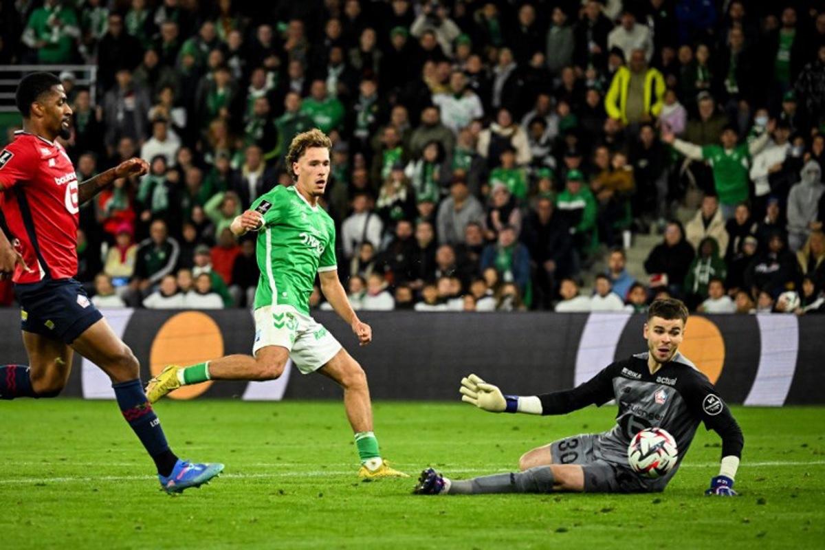 Saint-Etienne's Belgian forward #32 Lucas Stassin's (C) kicks the ball saved by Lille's French goalkeeper #30 Lucas Chevalier (R) during the French L1 football match between Saint-Etienne (ASSE) and Lille (LOSC) at the Geoffroy Guichard stadium in Saint-Etienne, on September 13, 2024. JEFF PACHOUD / AFP