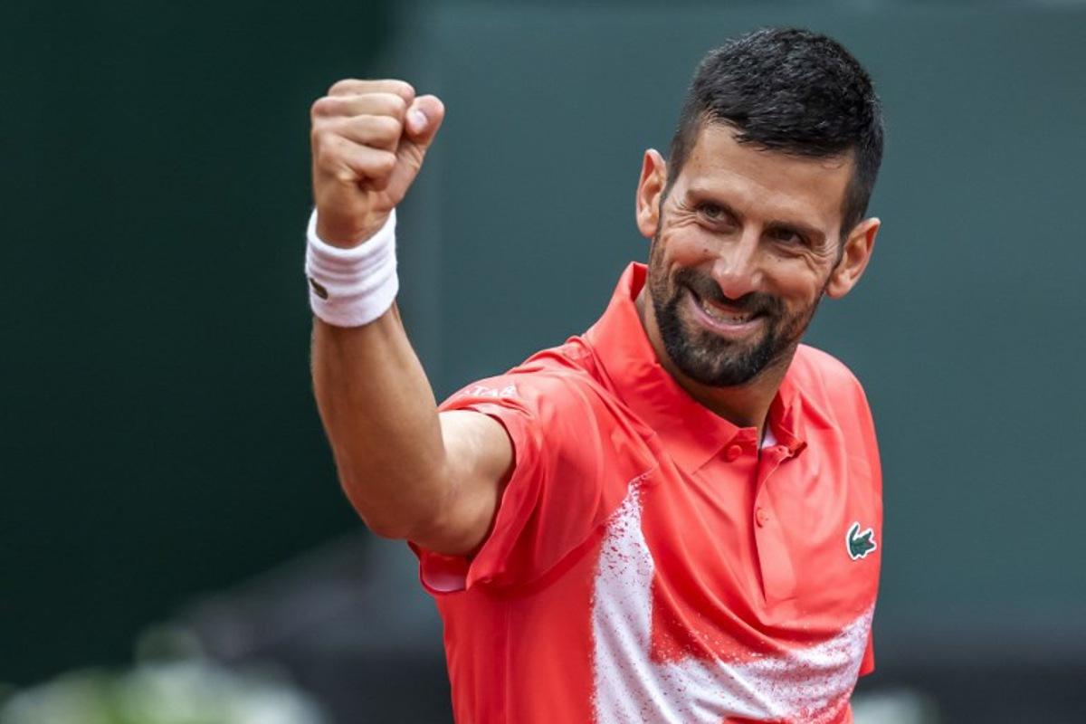 Serbia's Novak Djokovic celebrates his victory at the end of his match against Hungary's Marton Fucsovics at the ATP 250 Geneva Open tennis tournament in Geneva on May 21, 2025. FABRICE COFFRINI / AFP