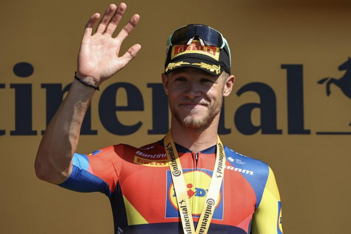 Lidl - Trek team's Italian rider Jonathan Milan celebrates on the podium after winning the 8th stage of the 112th edition of the Tour de France cycling race, 171.4 km between Saint-Meen-le-Grand and Laval Espace Mayenne, western France, on July 12, 2025. Anne-Christine POUJOULAT / AFP