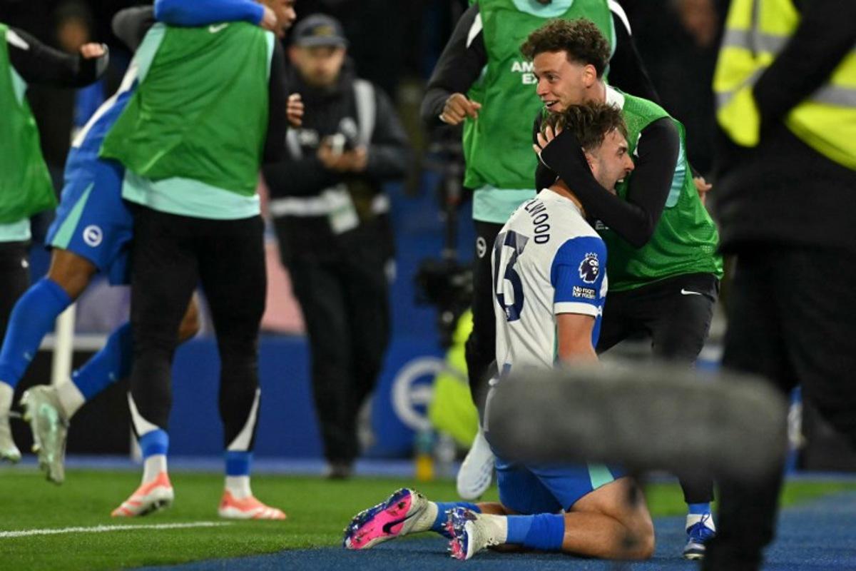 Brighton's English midfielder #13 Jack Hinshelwood (2R) celebrates with Brighton's substitutes after scoring their second goal during the English Premier League football match between Brighton and Hove Albion and Chelsea at the American Express Community Stadium in Brighton, southern England on April 21, 2026. Glyn KIRK / AFP