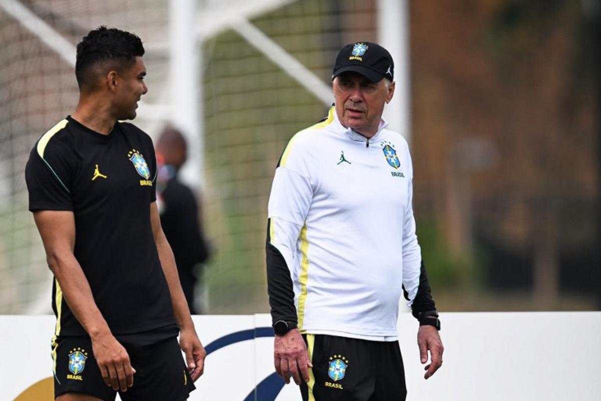 Brazil's Italian head coach Carlo Ancelotti (R) and Brazil's midfielder #05 Casemiro take part in an MD-1 training session at Columbia Park Training Facility in Morristown, New jersey, on June 18, 2026, on the eve of the World Cup 2026 Group C football match between Brazil and Haiti. MAURO PIMENTEL / AFP