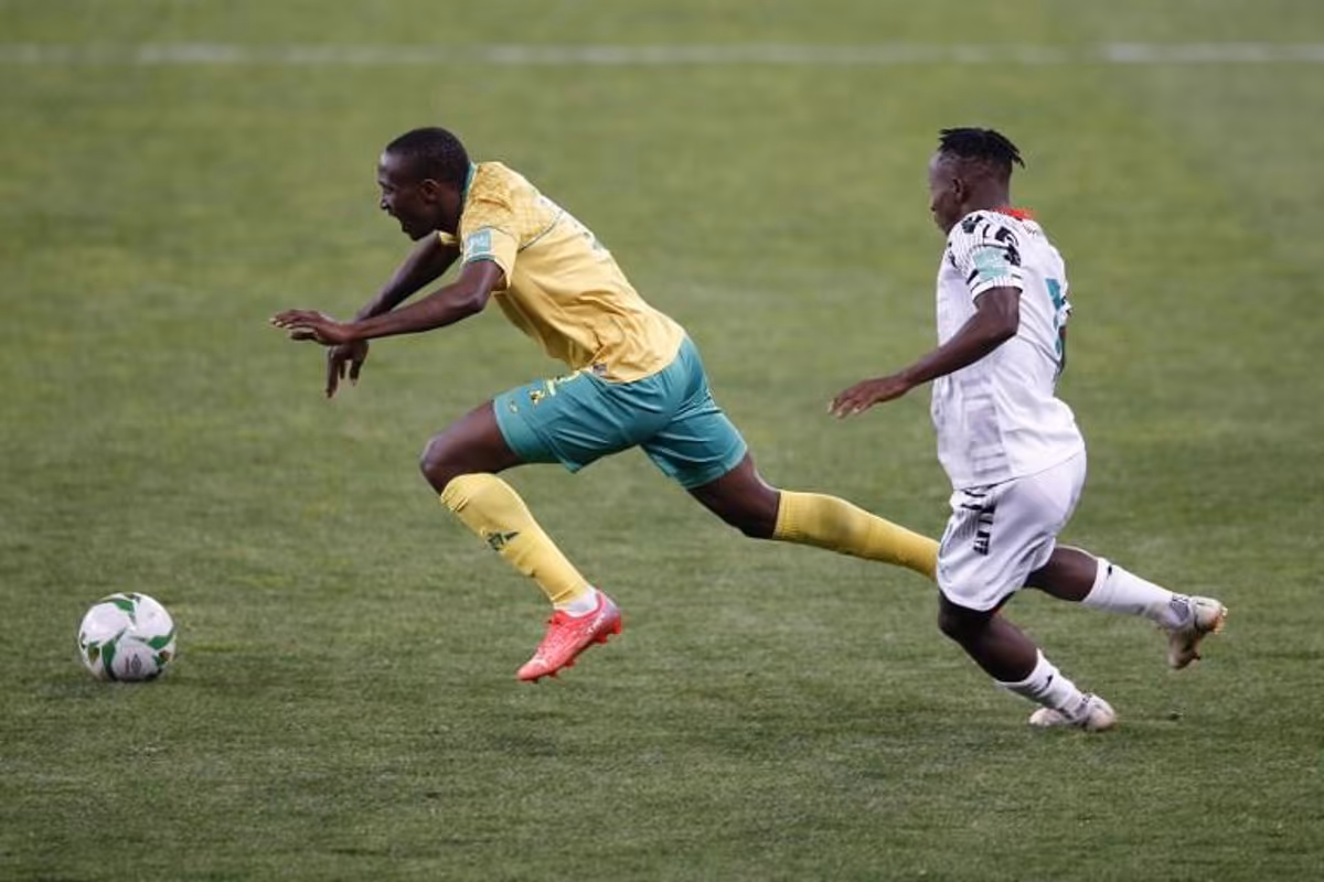 South Africa's Nyiko Mobbie (L) falls after being tackled by Ghana's Yaw Yeboah (R) during the FIFA World Cup Qatar 2022 qualifying round Group G football match between South Africa and Ghana at the FNB Stadium in Johannesburg on September 6, 2021. PHILL MAGAKOE / AFP