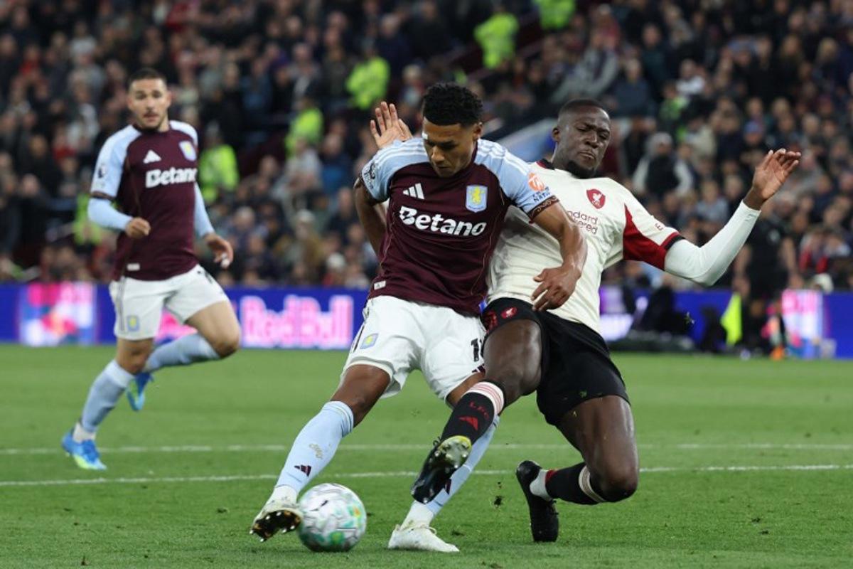 Aston Villa's English striker #11 Ollie Watkins (C) shoots past Liverpool's French defender #05 Ibrahima Konate (R) to score their second goal during the English Premier League football match between Aston Villa and Liverpool at Villa Park in Birmingham, central England on May 15, 2026. Darren Staples / AFP