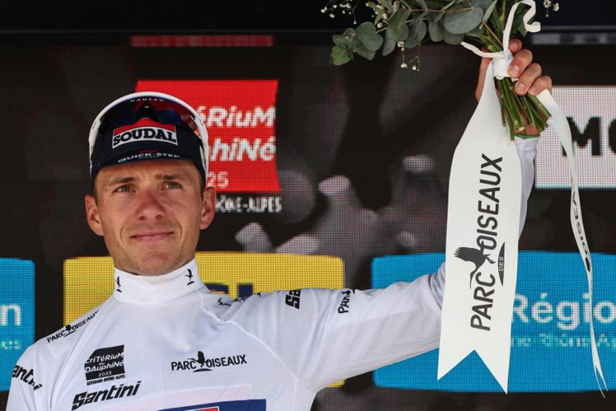 Soudal Quick-Step's Belgian rider Remco Evenepoel wearing the best young rider's white jersey celebrates on the podium of the 1st stage of the 77th edition of the Criterium du Dauphine cycling race, 195,8 km between Domérat and Montlucon, on June 8, 2025. Anne-Christine POUJOULAT / AFP