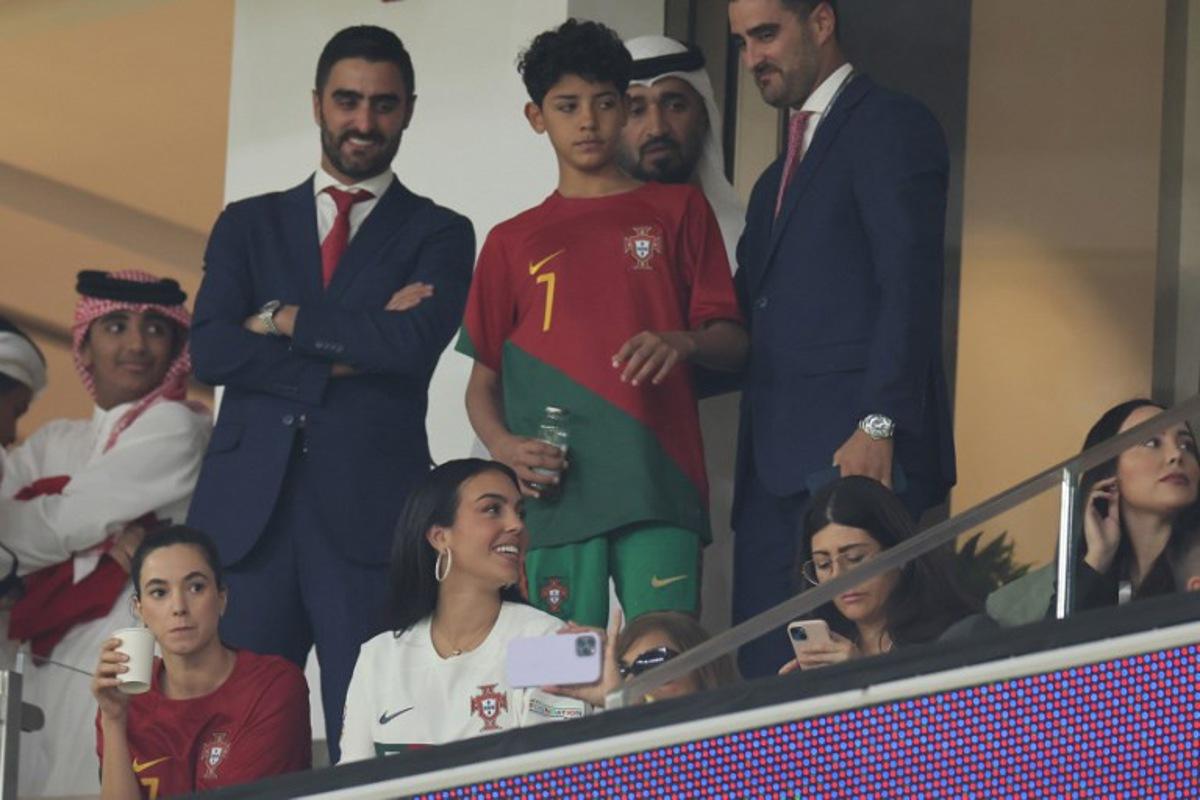 Portugal's forward #07 Cristiano Ronaldo's partner Georgina Rodriguez (bottom) and son Cristiano Ronaldo Jr (C) attend the Qatar 2022 World Cup quarter-final football match between Morocco and Portugal at the Al-Thumama Stadium in Doha on December 10, 2022. KARIM JAAFAR / AFP